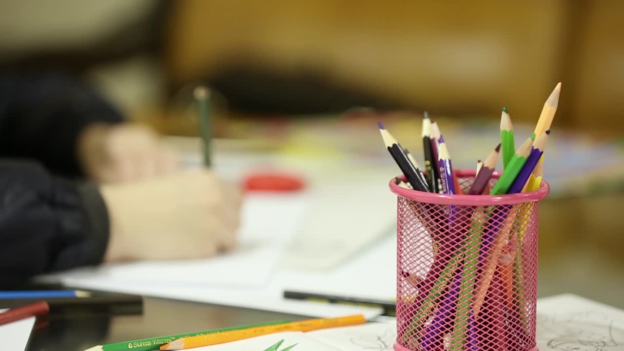 Little Kids Sitting At Table Drawing With Pencils. Cute little kids sitting at table drawing with colored pencils