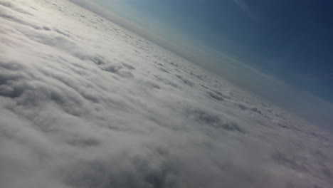 above the clouds - filmed at a dutch angle from a passenger airliner