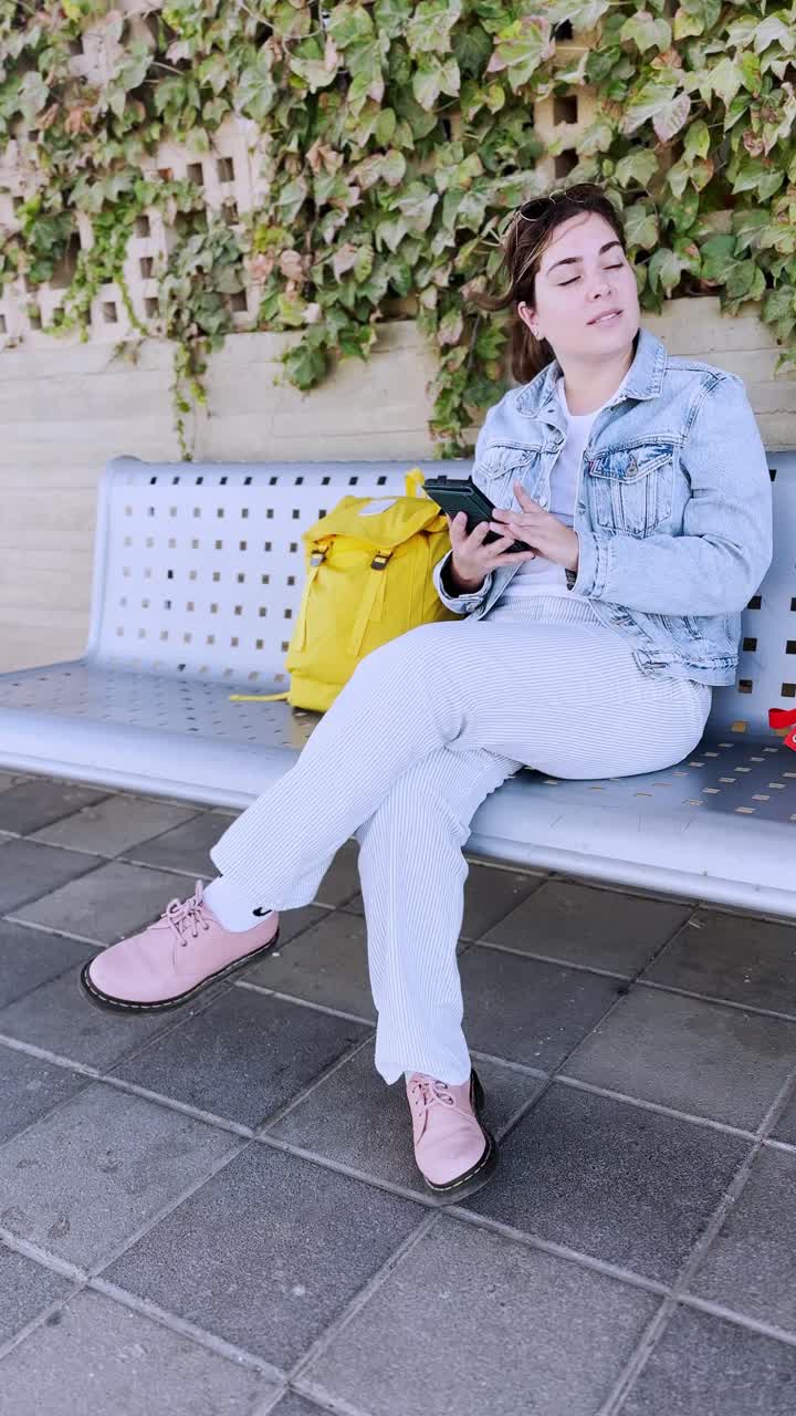 Relaxed Woman Waiting on a Bench at a Train Station