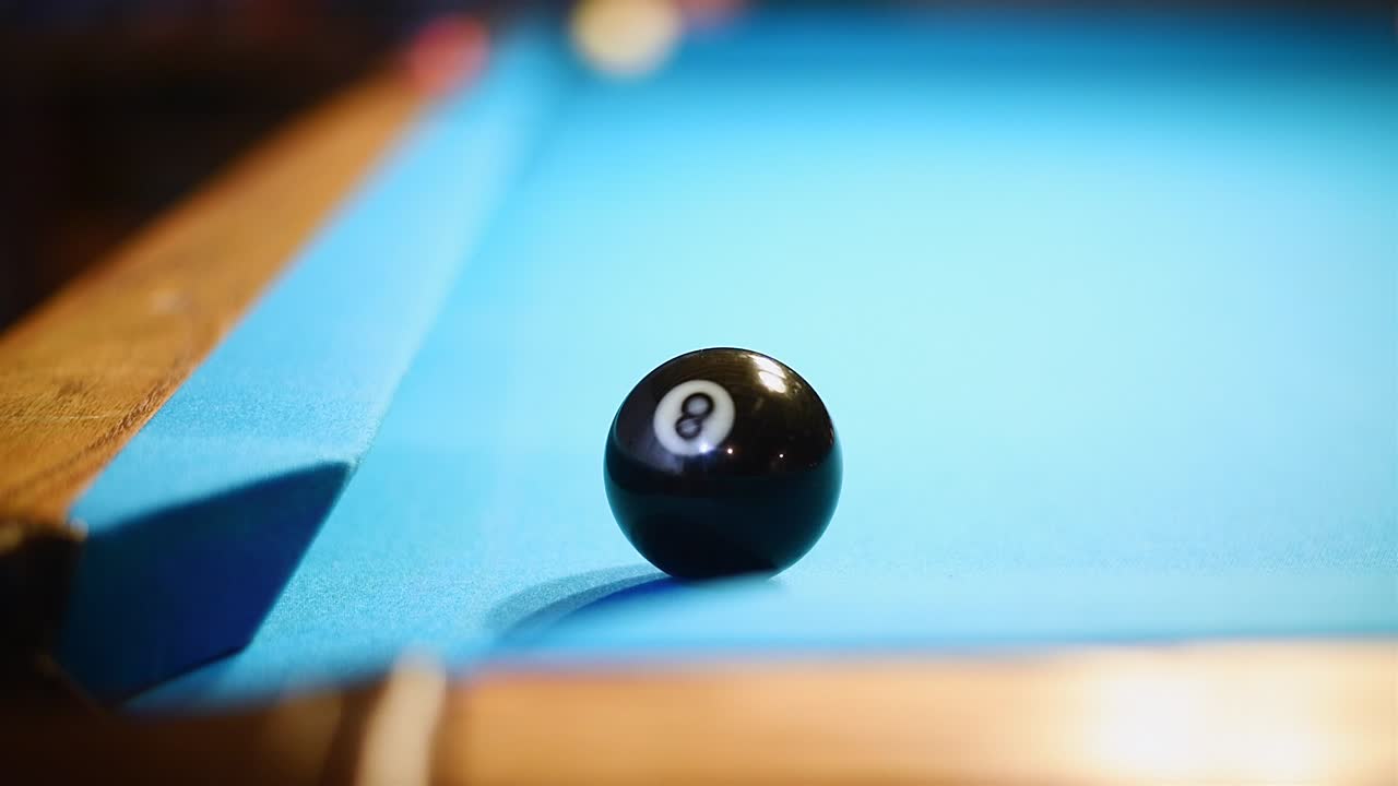 Long 8-ball shot on a blue cloth pool table