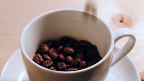 pouring coffee beans on a cup