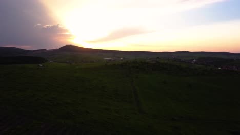 Aerial-view-of-sunset-over-a-hill,-Transylvania,-Romania