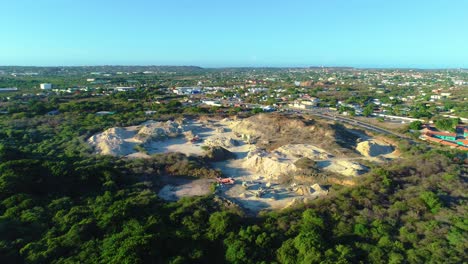 Drone-establishing-view-of-sandy-loam-fill-site-with-excavator-and-heavy-machinery