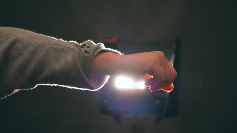 young woman, teenager, plays with the light moving her hand delicately, creating beautiful reflections of light, light leak