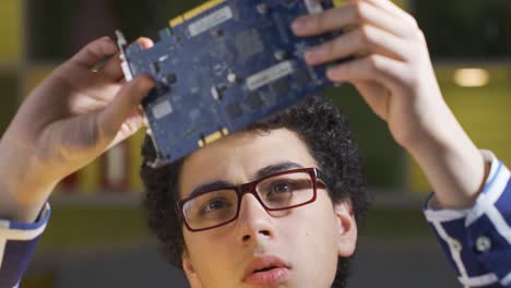 child fascinated by electronic card. he is examining him.