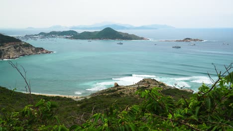 aerial wide shot showing beautiful ocean landscape with bay,beach and mountains in background