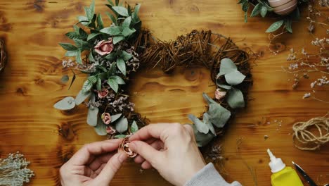 female hands makes spring floral wreath.