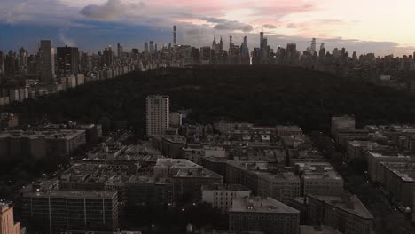 drone shot moving forward from harlem nyc towards the upper east side at sunset in 4k