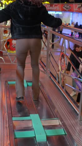 person walking on a moving platform at an amusement park