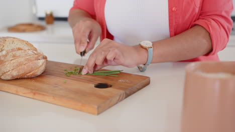 chopping fresh herbs on cutting board, asian woman preparing ingredients in kitchen, at home