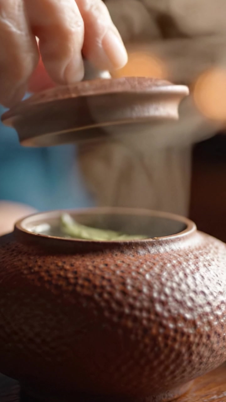 A Beautifully Crafted Traditional Teapot with Steam Rising in a Cozy Setting, Highlighting the Art of Tea Preparation and Its Aesthetic Appeal in Focused Detail