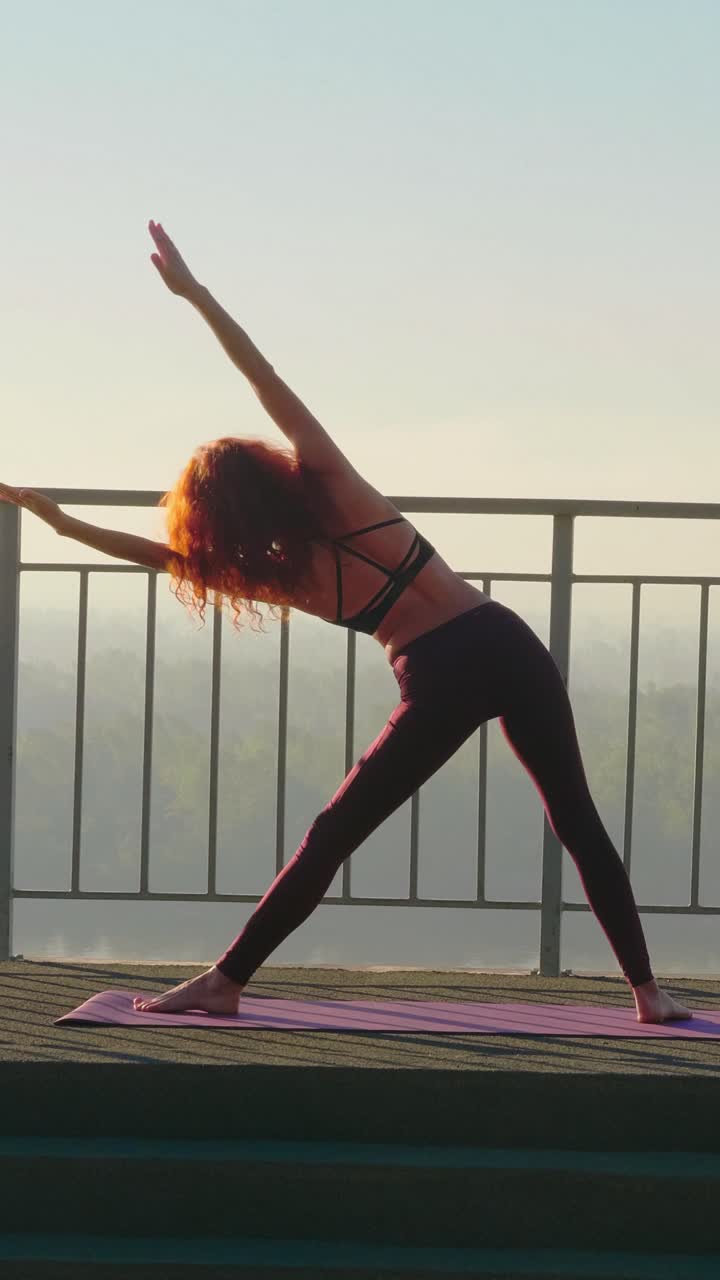 Woman practicing yoga in outdoor setting with scenic view and morning sunlight illuminating surroundings