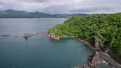 a 4k drone shot of punta sabana point and the mirador conchal peninsula next to puerto viejo and playa conchal, or “shell beach”, along the north-western coast of costa rica