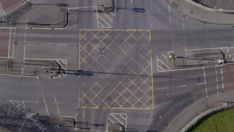 timelapse at a major four way intersection on a sunny day. aerial top down