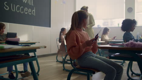 children using digital tablets at lesson. girl holding tablet computer