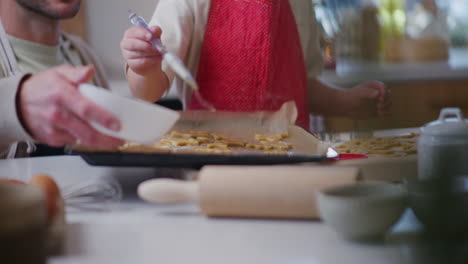 dad and son prepare holiday pastries