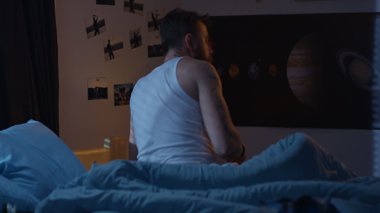 Teenager in bedroom at night