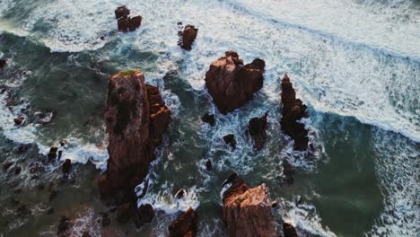 aerial view of rocky coastline with waves