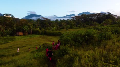 drone shot of tribal people heading to village