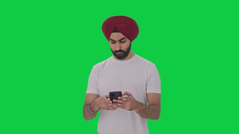 sikh indian man texting someone green screen