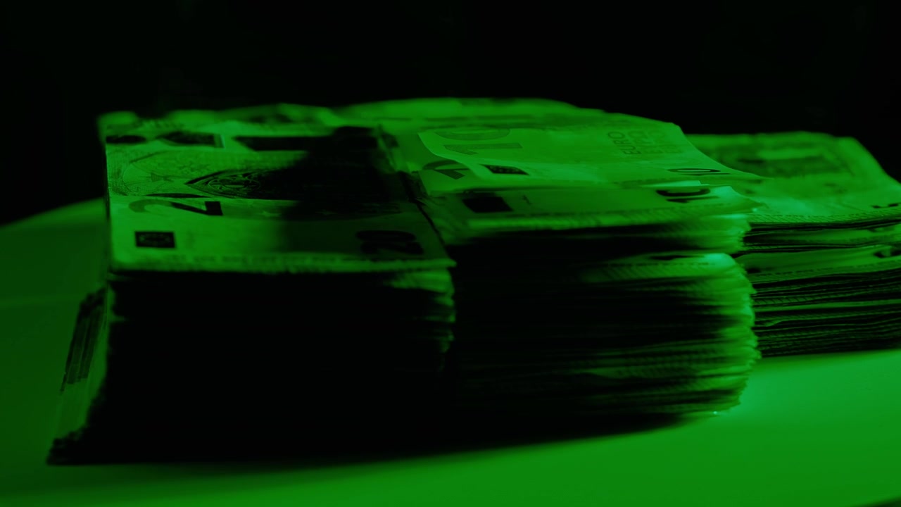Rotating Euro Banknote Stacks Under Green Light Close Up Finance Concept