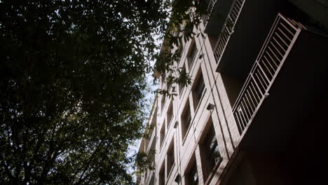 apartment building with balconies and trees