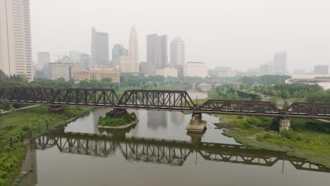 aerial view of columbus ohio skyline with train tracks bridge flyover on a foggy smoky day