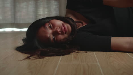 sad and depressed asian woman lying on the floor