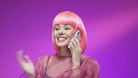 close up of cheerful woman wearing a pink wig