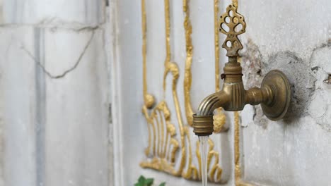 close-up of a traditional brass water fountain in istanbul