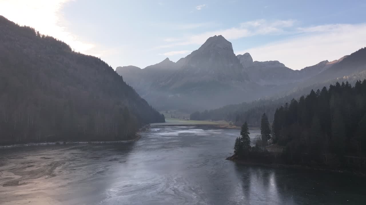 Drone aerial of Obersee lake, Mols, Walenstadt, Switzerland – majestic mountains reflecting in pristine alpine waters.
