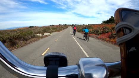 family of three enjoying the outdoors and biking on the scenic monterey bay coastal biking trail in california, usa