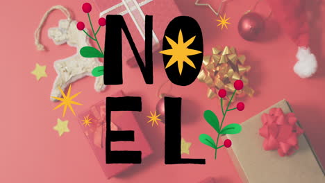 animation of noel text banner over christmas gifts and decorations on red surface