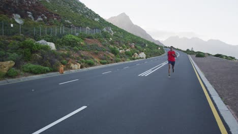 african american man wearing sportswear running on the road