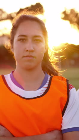 female soccer players standing with arms crossed on soccer field. 4k