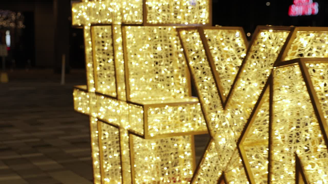 밤에 불이 켜진 거대한 led "xmas" 기호의 아름다운 슬로우 모션 팬