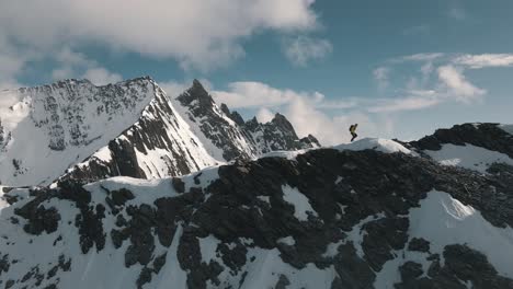 mountaineer walks along the ridge to a summit