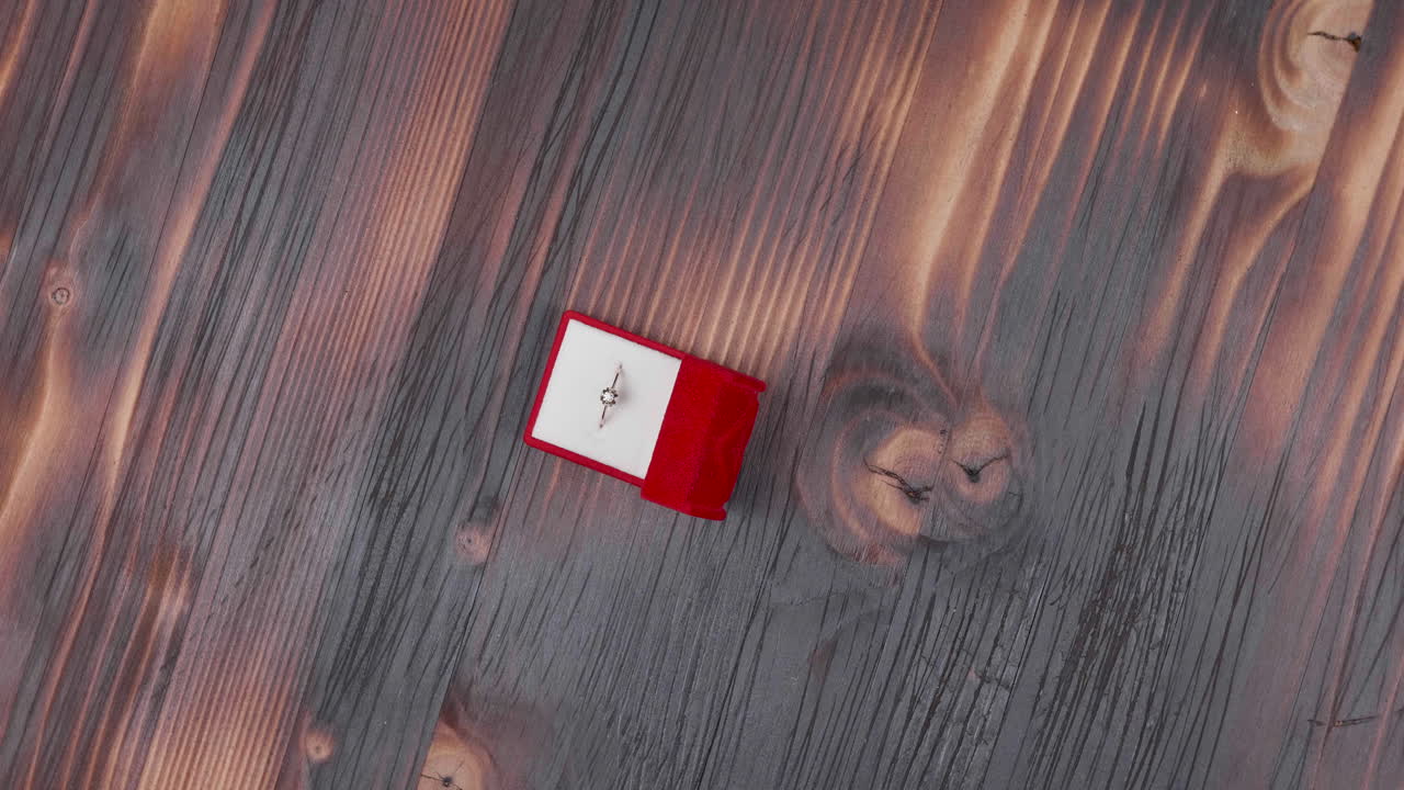 Engagement ring on wooden background