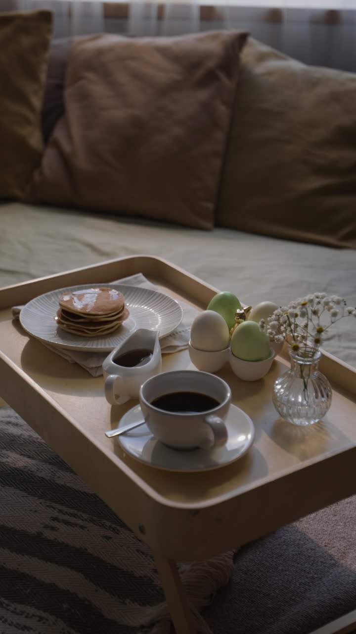 Breakfast Tray with Pancakes, Coffee, and Easter Eggs on Sofa