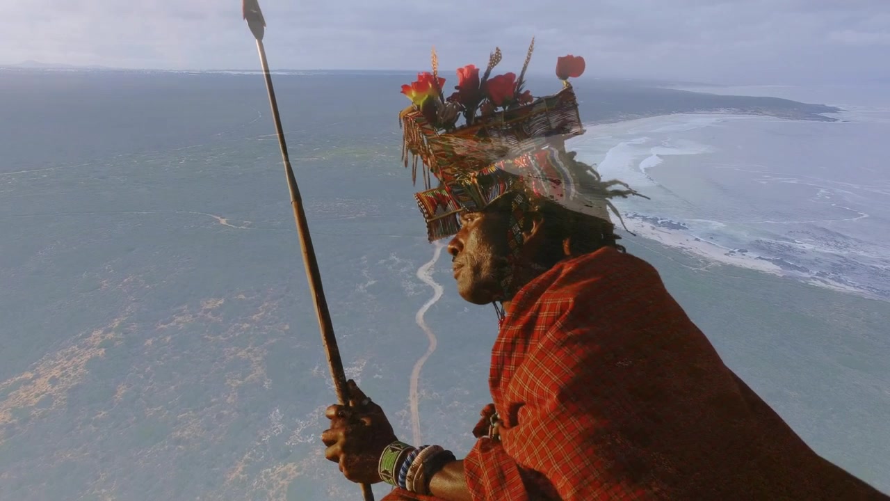 Animation einer Landschaft über einem afroamerikanischen Mann in traditioneller Kleidung.