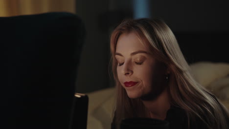 woman with red lipstick in a dark room
