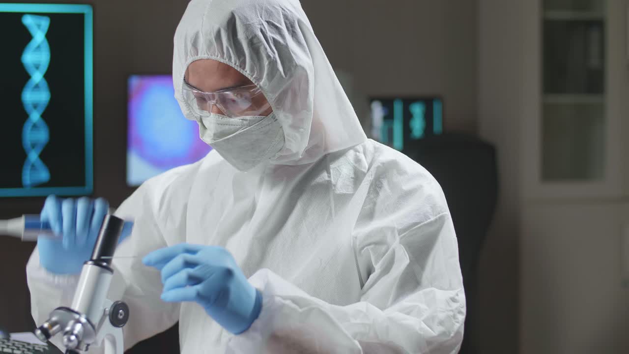 Asian Doctor In Protective Suit Working And Developing Vaccine In A Modern Lab. Laboratory Assistant Workplace. The Concept Of Science And Medicine