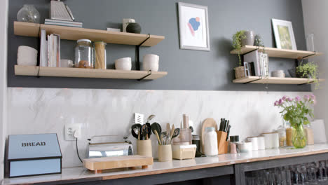 Close-up-of-sunny-kitchen-with-plants-and-flowers,-slow-motion