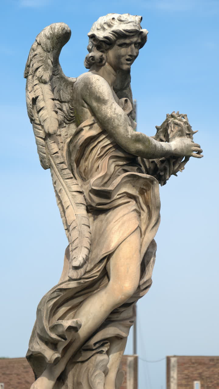 Marble statue of angel on Saint Angel Bridge in Rome, Italy. Vertical