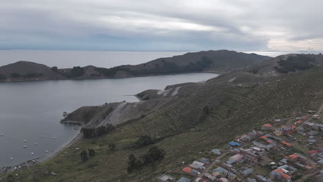 drone shot above isla del sol near copacabana bolivia titicaca lake on a cloudy day with view on the sea and the islands log