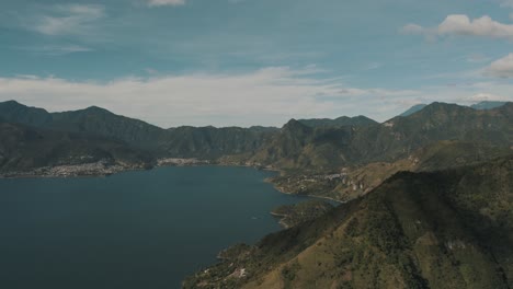 drone aerial landscape overview of lake atitlan in guatemala surrounded by volcanoes and mountains