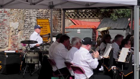 musicians playing instruments under a canopy