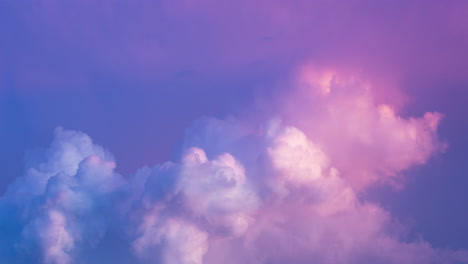 colourful pastel pink and blue storm clouds bubbling during the setting evening sun