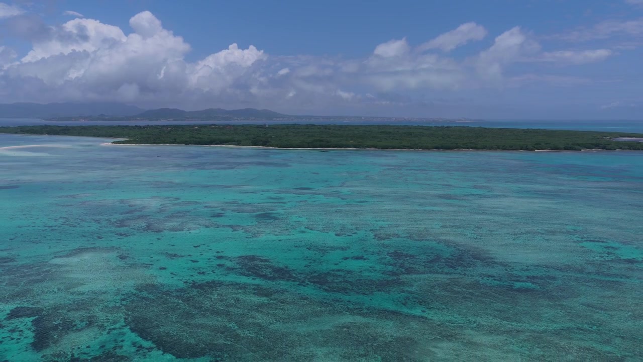 Ripresa orizzontale con carrello all'indietro sopra acque costiere turchesi e barriera corallina vicino al molo Nishi e alla spiaggia Kondoi, Isola di Taketomi, Okinawa, Giappone