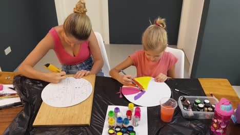 mother and daughter painting together